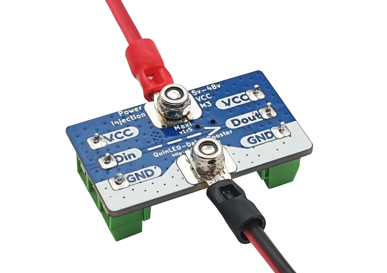 QuinLED Data-Booster blue PCB tilted top view showing VCC/Din/Dout/GND labels and two nut-fixed screws, with red and black wires attached
