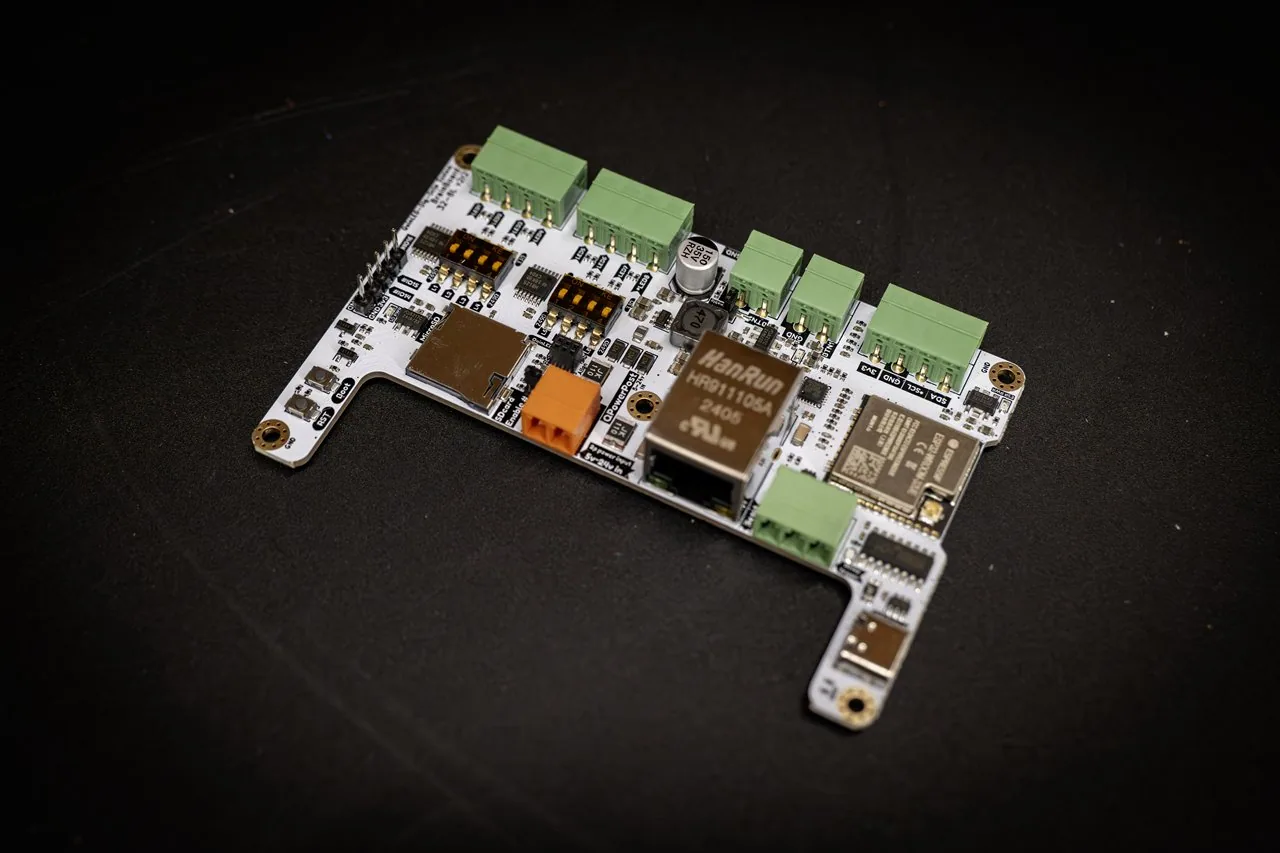 QuinLED Dig-Octa Brainboard-32-8L angled view of the white PCB with Ethernet jack, ESP32, microSD slot and empty green terminals