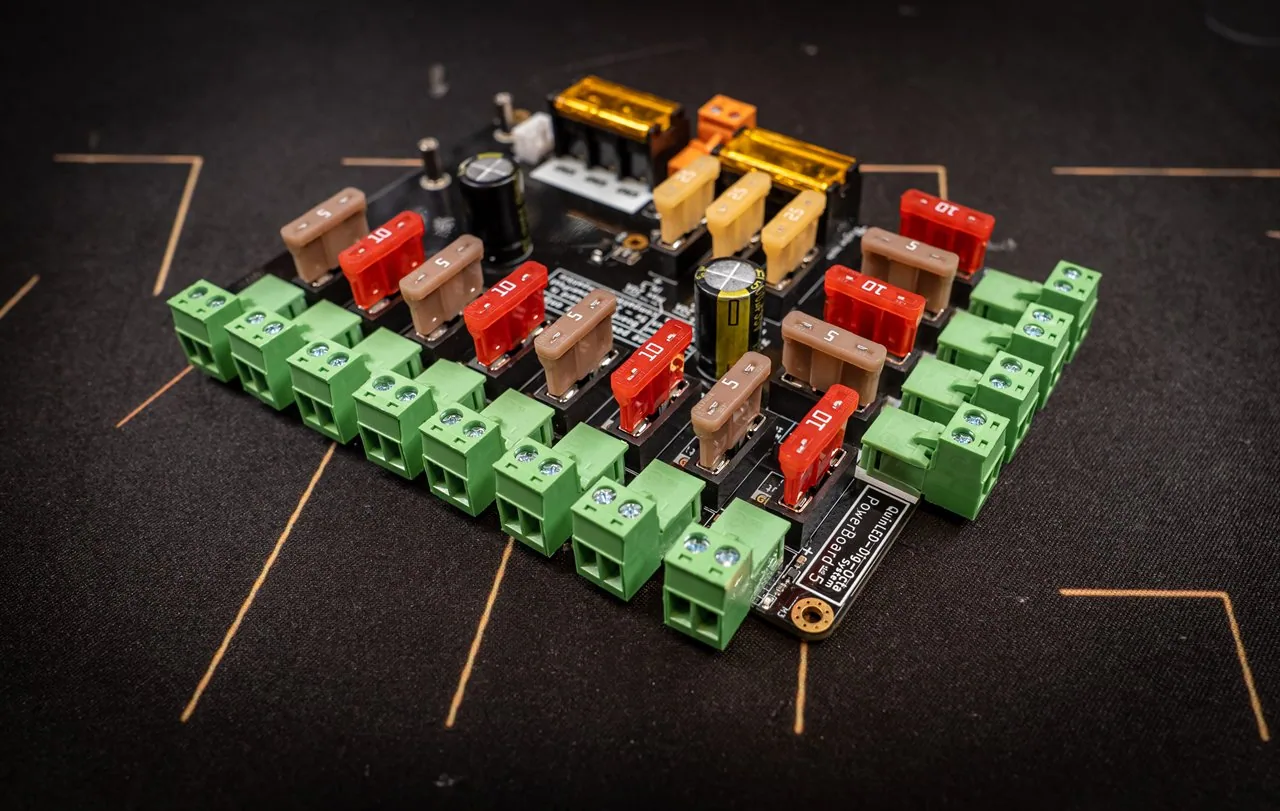 QuinLED Dig-Octa Power-5 angled view showing the pluggable green connectors clipped around the board edge with blade fuses
