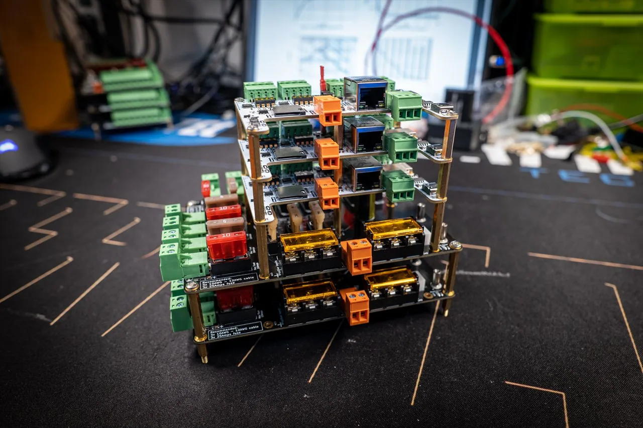 QuinLED Dig-Octa System tower: several stacked Brainboard and Powerboard units with Ethernet jacks, blade fuses and gold bolt fuse holders