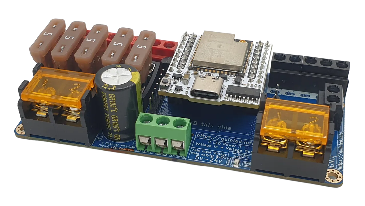 QuinLED Dig-Quad angled close-up, ESP32 with USB-C, fuse bank, capacitor, orange output terminals and green terminal