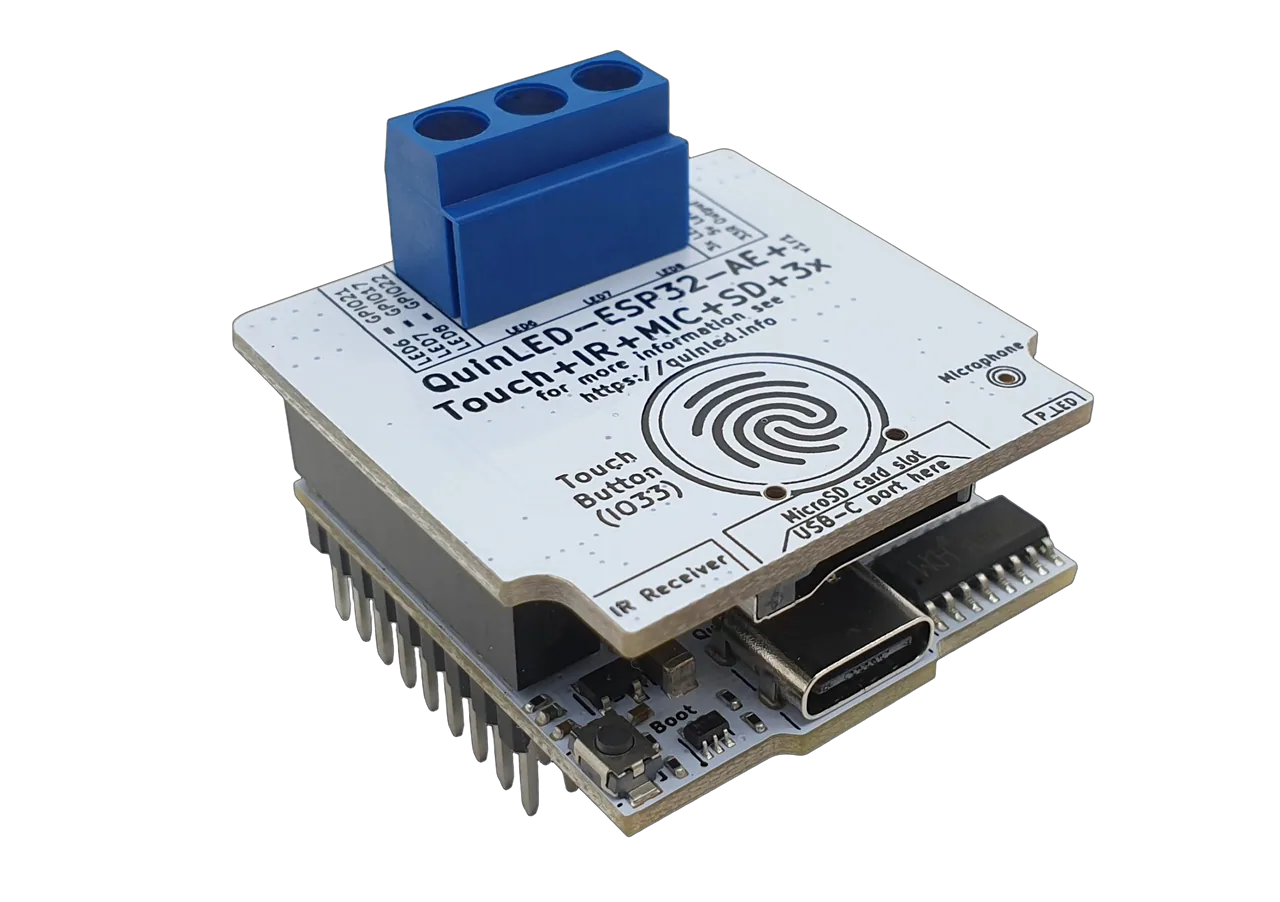 QuinLED-ESP32-AE+ assembled module angled view: blue 3-pin screw terminal, touch button, microphone, IR receiver, USB-C and heatsink pins